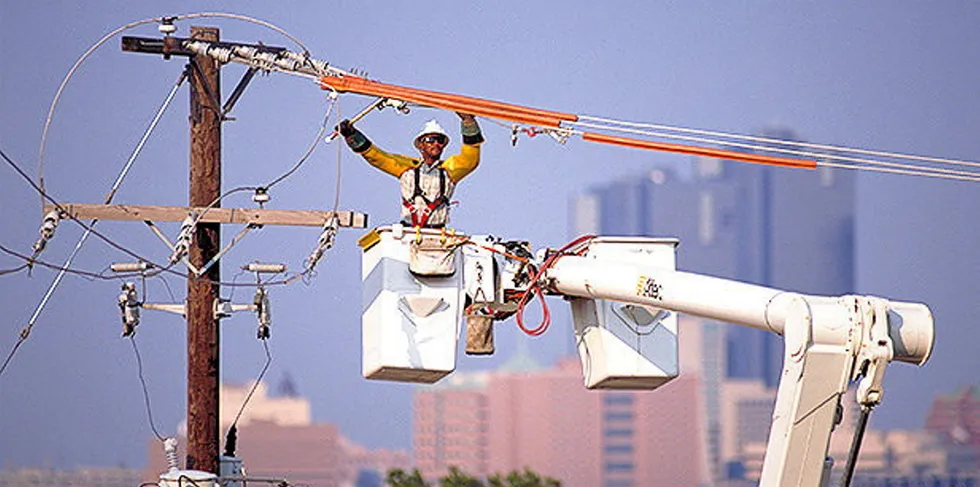 Oncor technician works on an overhead powerline