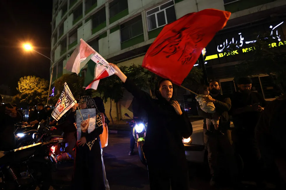 Demonstrators celebrate during a rally in Tehran on 1 October after Iran fired a barrage of missiles into Israel in response to the killing of Hezbollah leader Hassan Nasrallah and other Iranian-backed militias.