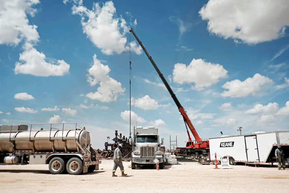Forecasts: Chevron personnel at a fracking site in the Permian basin near Midland, Texas