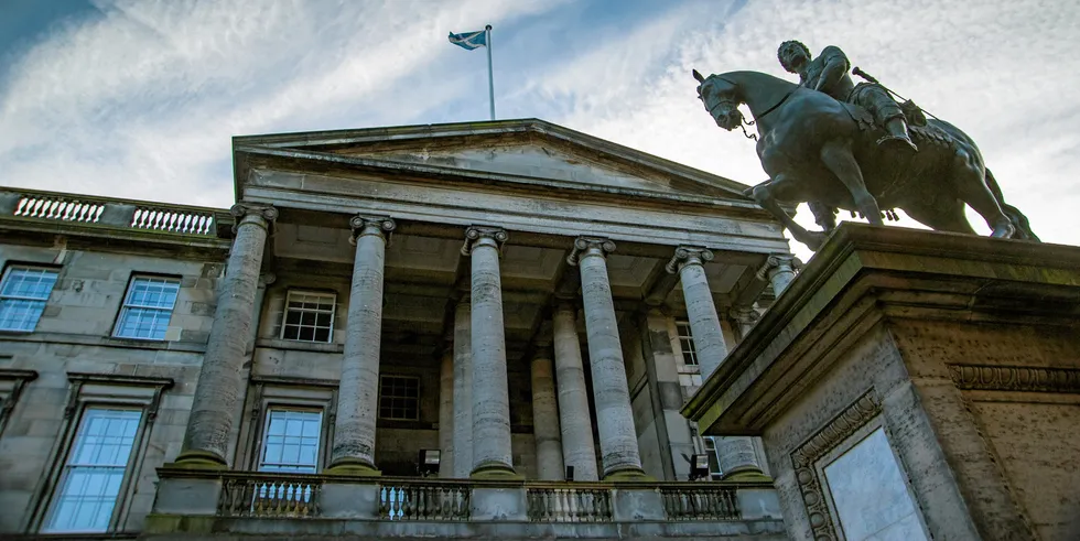 A view of Court of Sessions buildings with an equestrian statue of Charles II of Scotland.