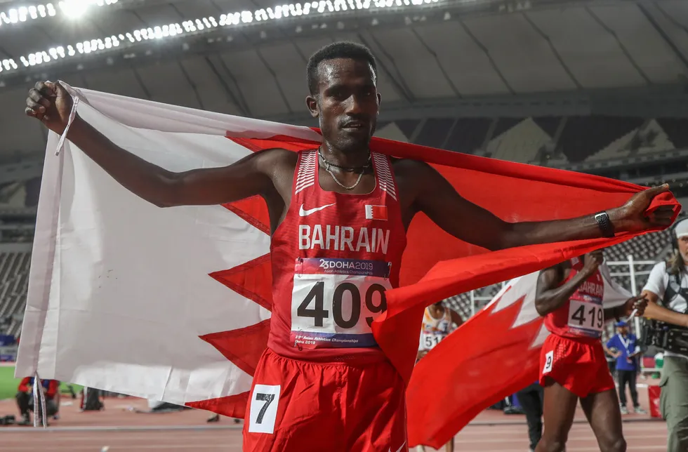 Celebration: Birhani Balew with the Bahrain national flag after men's 5000-metre race at the 23rd Asian Athletics Championships