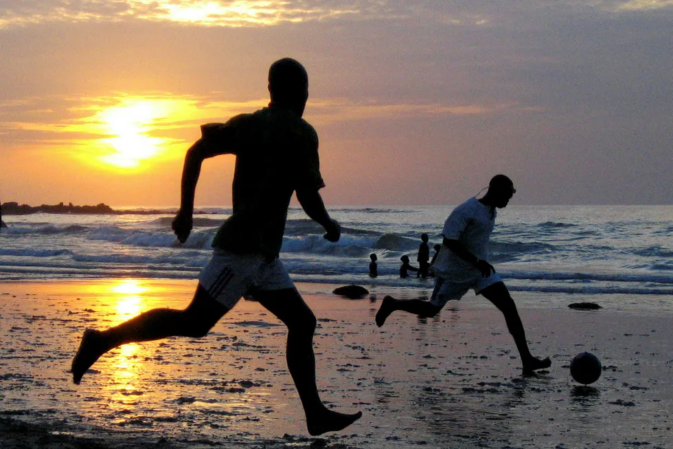 Game on: a youth plays football on the beach during sunset in Senegal's capital Dakar