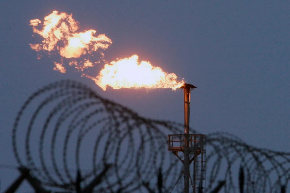 Fence off: associated gas is flared at the South Russkoye oil and gas field in West Siberia