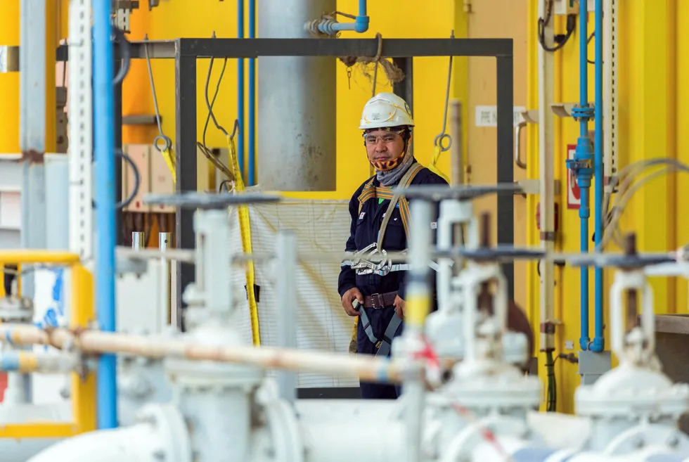 Looking to the future: a worker at an Adnoc facility. Adnoc, Saudi Aramco and Qatar Petroleum are all striving to reduce carbon emissions