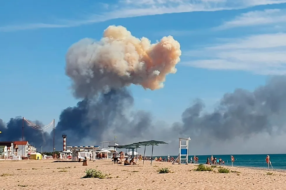 Rising smoke is seen from the shore of the Crimea Peninsula after explosions were heard from the direction of a Russian military airbase in August 2022.