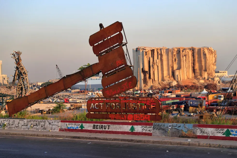 New round: a monument that represents justice stands in front of towering grain silos that were gutted in the massive August 2020 explosion at Beirut port in Lebanon that killed more than 200 people and wounded over 6000.