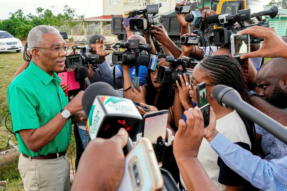 Holding on: President David Granger of the ruling National Unity and Alliance for Change coalition speaks with journalists after voting in the 2 March election