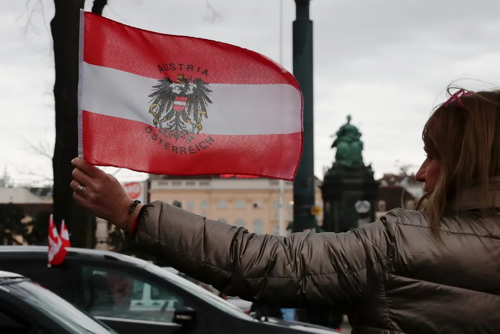 A women holds an Austrian national flag in 2022.