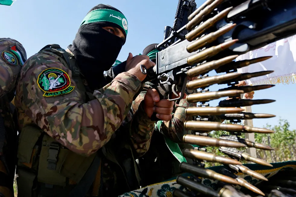En palestinsk Hamas-kriger viser frem sitt enkle våpen i en militærparade i juli i Gaza.