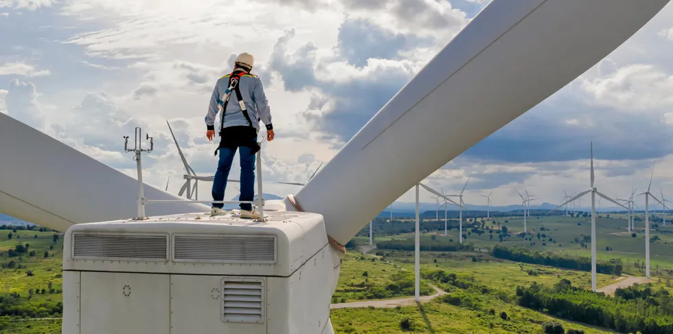 A wind technician on a turbine.