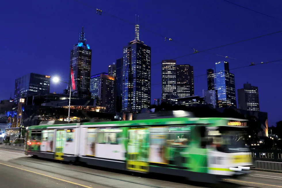 Energy demand: the Melbourne city skyline is seen as a tram crosses the Princes Bridge at dusk