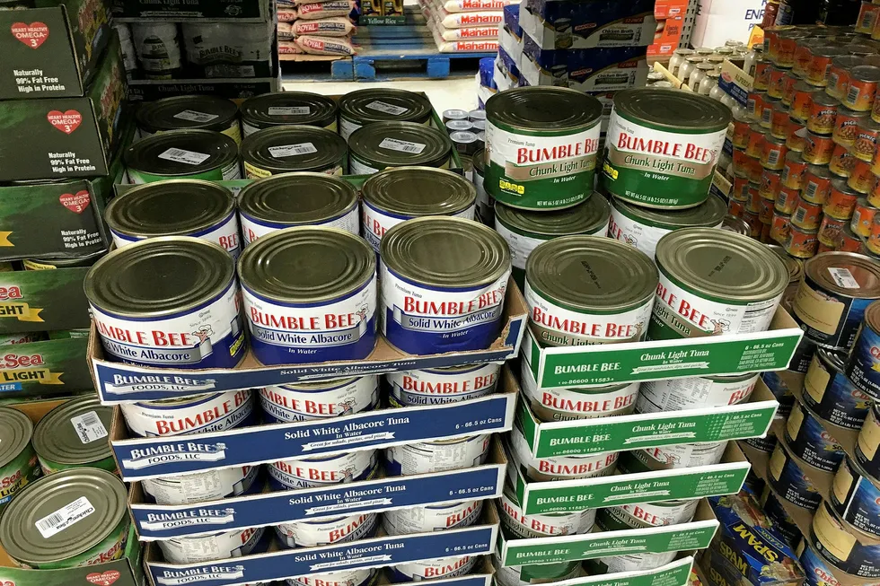 Bumble Bee tuna cans stacked high. The company and its former executives remain in trouble.