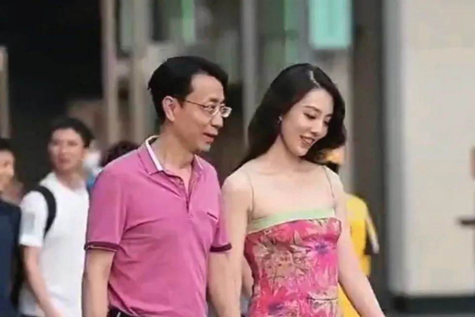 Caught on camera: PetroChina official Hu Jiyong videoed holding hands with a female colleague in Chengdu's shopping area last week.