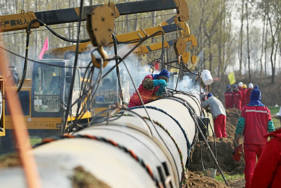 Under new management soon: workers lay pipeline for CNPC, which currently operates the bulk of China's oil and gas pipelines