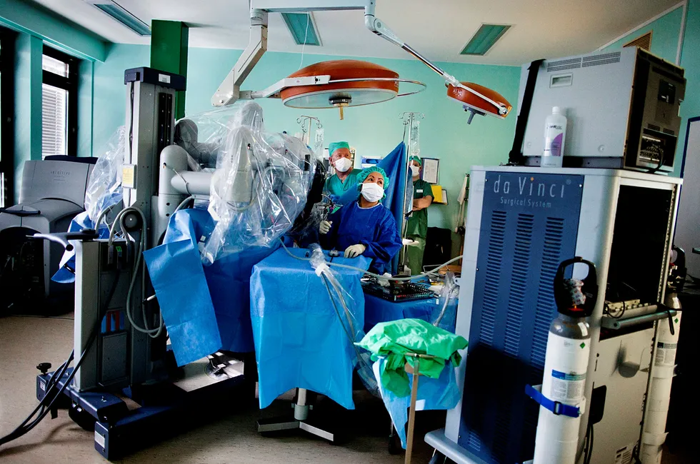 Anestesisykepleier Erik Helmich Pedersen (fra venstre) og operasjonssykepleier Josefine Waage gjennomfører en prostataoperasjon med en robot. Foto: Per Thrana