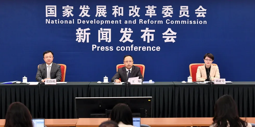 Wang Xiang of China's National Development and Reform Commission, centre, at the press conference in Beijing.