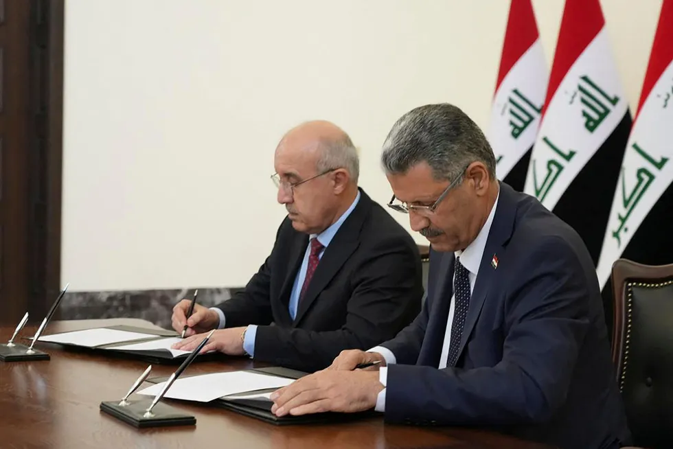 Making it official: Iraqi Oil Minister, Hayan Abdul-Ghani, (right) and Kurdish Minister of Natural Resources, Kamal Muhammad, sign an oil export deal.