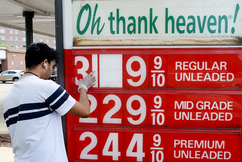 On the rise: an employee adjusts gasoline prices at a filling station in Virginia, near Washington DC