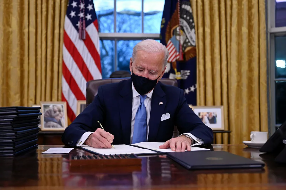 In the White House: US President Joe Biden signs a series of orders in the Oval Office, including a decision to rejoin the Paris climate accord