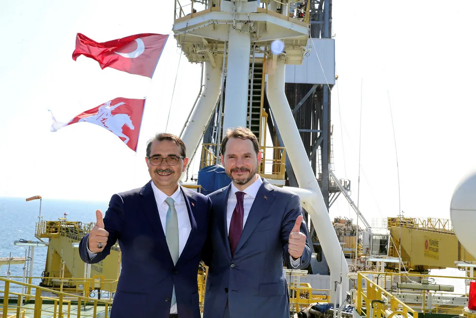Turkish Finance Minister Berat Albayrak and Energy Minister Fatih Donmez pose on the deck of drilling vessel Fatih in the western Black Sea, off Turkey, 21 August, 2020