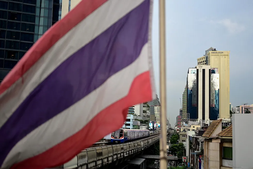 Capital city: the Thai national flag flutters in the wind as a BTS Skytrain goes by in Bangkok on 24 August