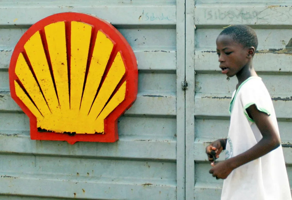 Troubled times: a schoolboy walks past a Shell sign in Niger Delta