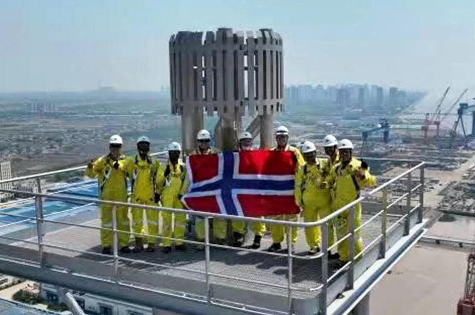 Yinson staff in China holding the Norwegian flag.
