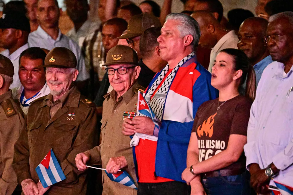 In tune: Cuban President Miguel Diaz-Canel (in colouful shirt) takes part in a ceremony in Havana, earlier this year.