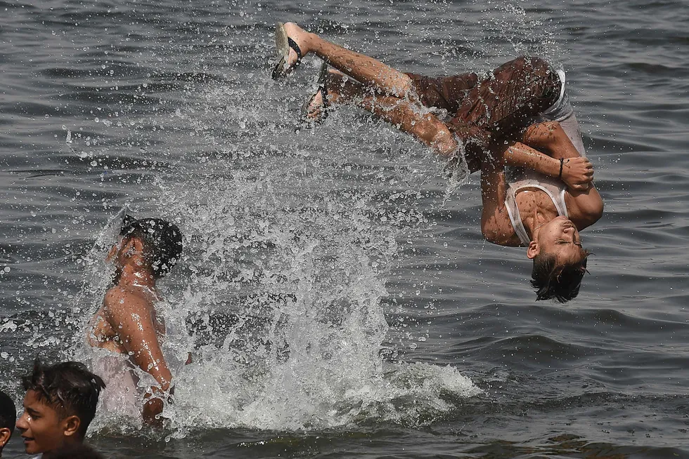 Jumping in: youths cool off in the waters of the Arabian Sea in the city of Karachi in Pakistan