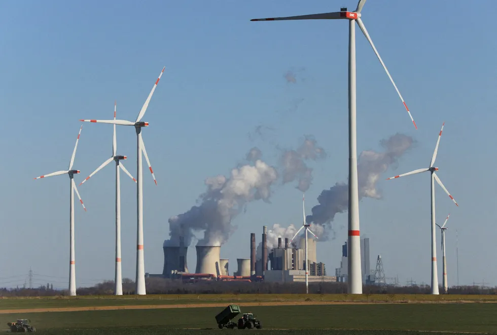 Receding: : Wind farm operated by German utility RWE pictured in front of lignite power plants, Neurath, Germany, March 2022.