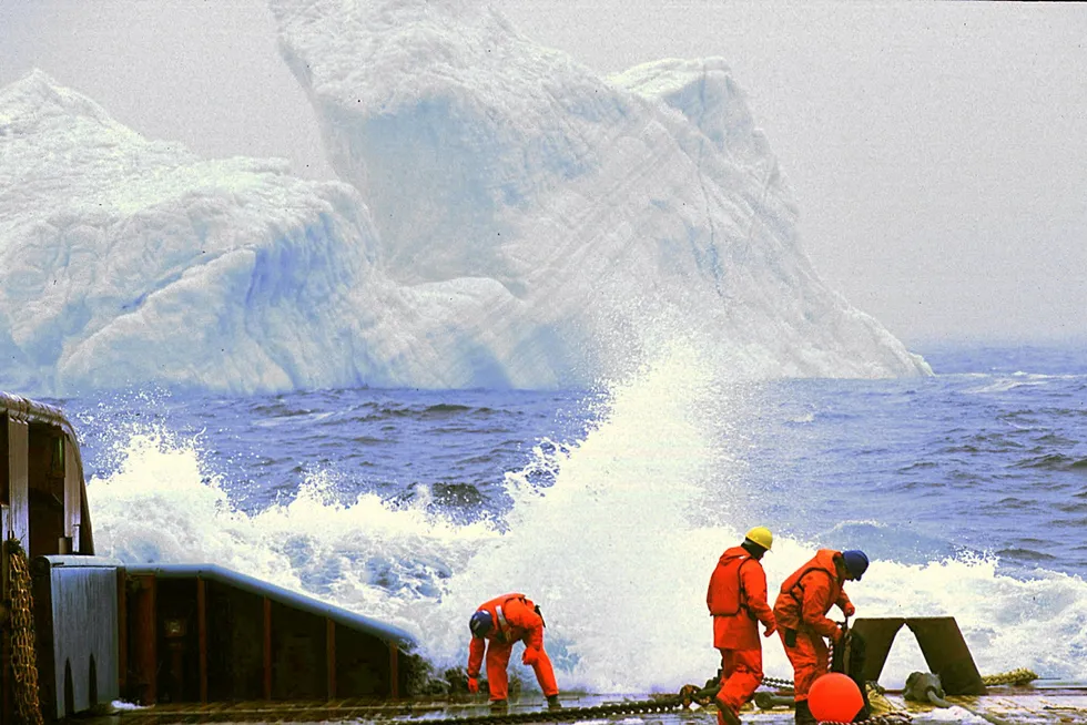 Mammoth task: workers on a platform supply vessel off Newfoundland, Canada attach tow cables to a 150,000-tonne iceberg in the vicinity of the Hibernia platform