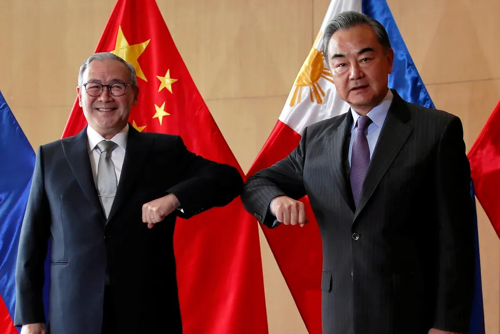 New focus: Philippine Foreign Affairs Secretary Teodoro Locsin Jr (left) and Chinese Foreign Minister Wang Yi bump elbows during a meeting in Manila on 16 January