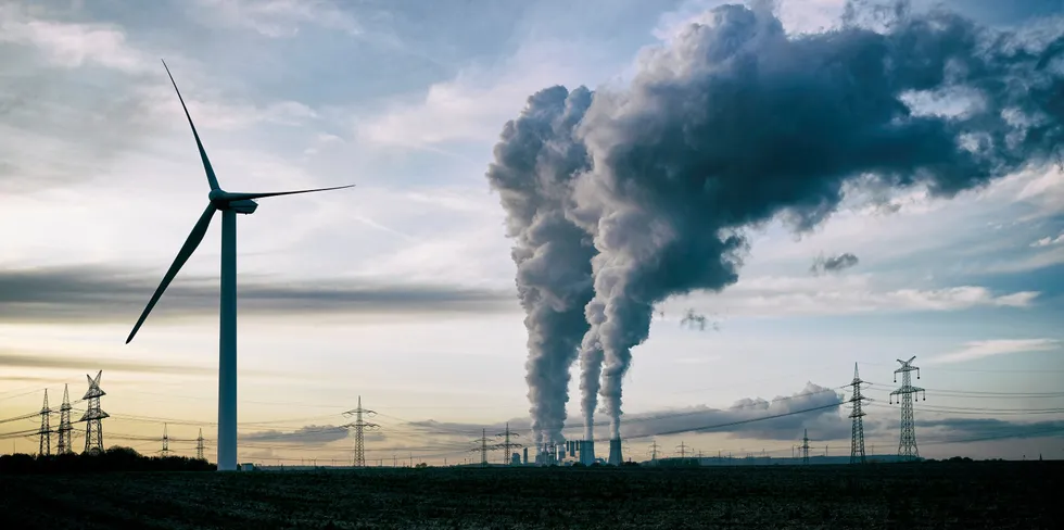A wind turbine near a coal plant in Germany.