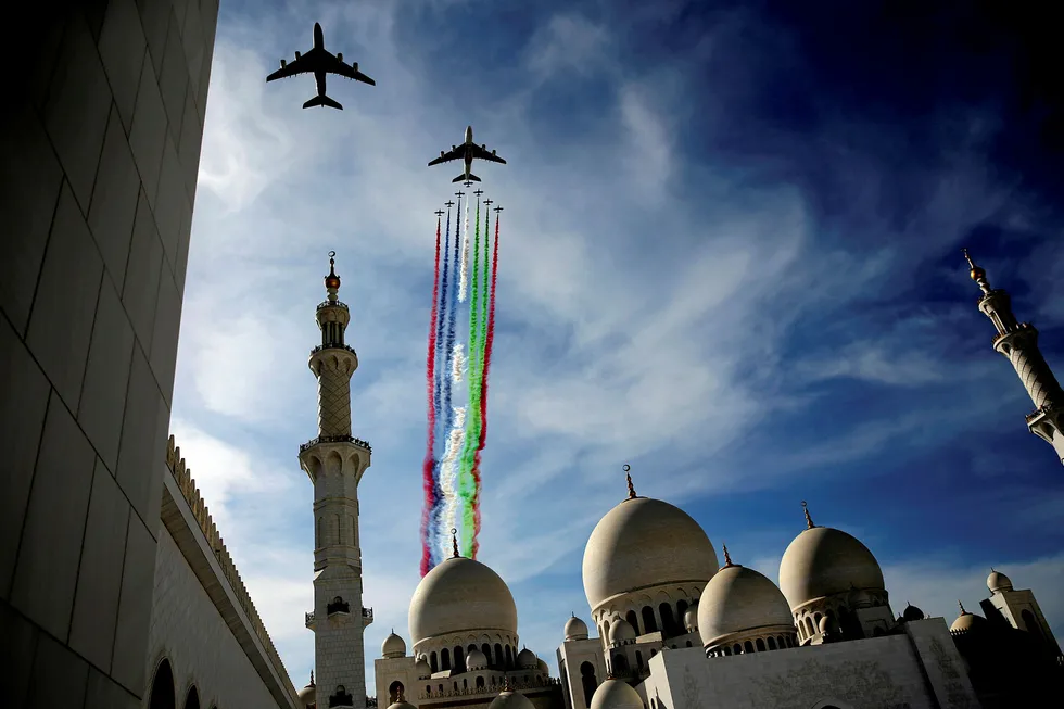 Streaming ahead: two airliners, followed by the Al Fursan aerobatic team, perform a display show over the Sheikh Zayed Grand Mosque in Abu Dhabi in the United Arab Emirates