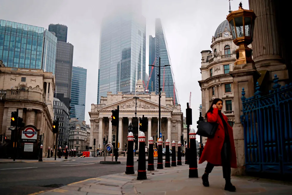A pedestrian walks near the Royal Exchange and the Bank of England in the City of London on the bank holiday, December 28, 2020, as Londoners continue to live under Tier 4 lockdown restrictions. - Business breathed a sigh of relief this week after a post-Brexit trade deal was agreed, but many issues remain unresolved, notably the place of financial services, which represent 80 per cent of the British economy, as the newly inked deal focuses on trade in goods. (Photo by Tolga Akmen / AFP)