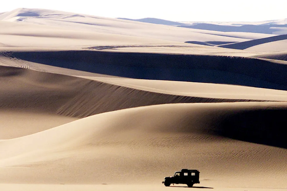 Apex core area: A four wheel drive vehicle crosses the sand dunes near Egypt's Western Desert oasis town of Siwa.