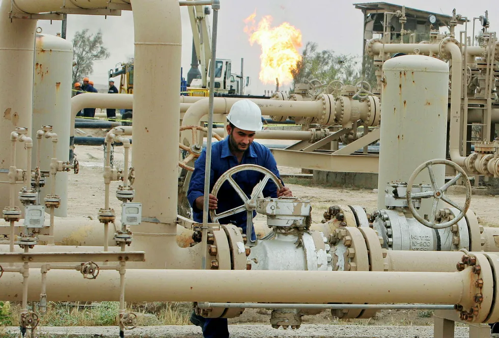 Iraq oil: Iraqis work on an oil and gas facility near Basra