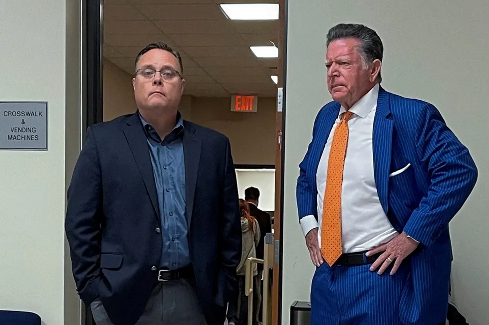 Discharged: Former ExxonMobil senior vice president David Scott (left) waits outside a Texas courtroom with his defence attorney Dan Cogdell in Conroe, Texas, US in October 2023.