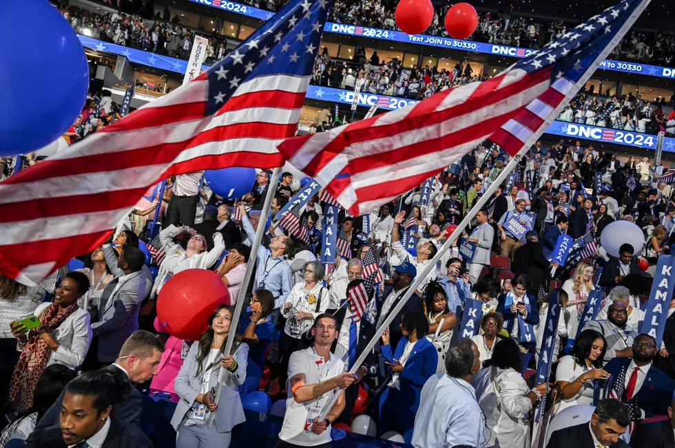 Attendees wave the nation's flag after a US election campaign rally.