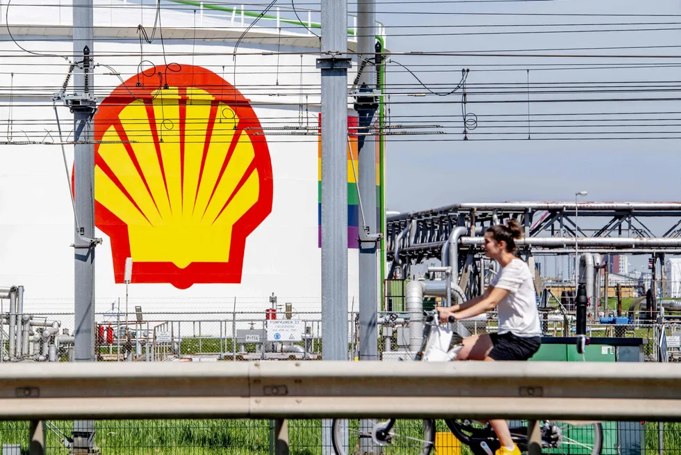 Hydrogen deal: A woman rides her bicycle past the Shell Pernis refinery site in the Netherlands. A deal between Shell and Worley to build a large green hydrogen facility is aimed to help decarbonise the refinery.