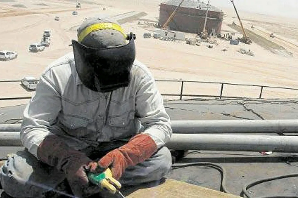 Working out: a man works at an oil storage tank near Karbala, near to the Garraf field