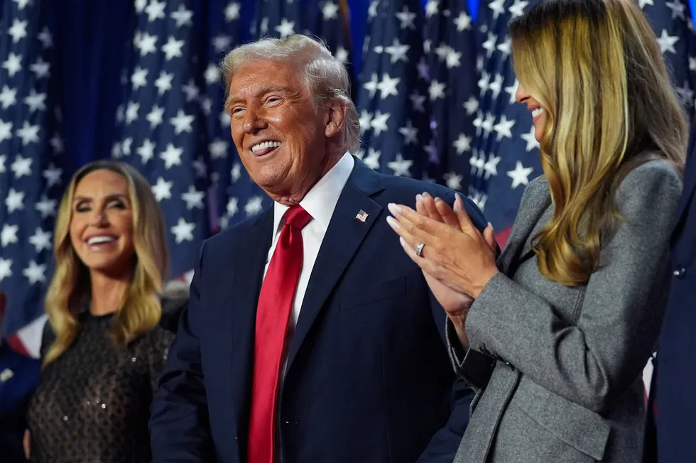 Republican presidential nominee and former president, Donald Trump stands on stage with former first lady Melania Trump, as Lara Trump watches, during an election night watch party at the Palm Beach Convention Center in Florida on Wednesday.