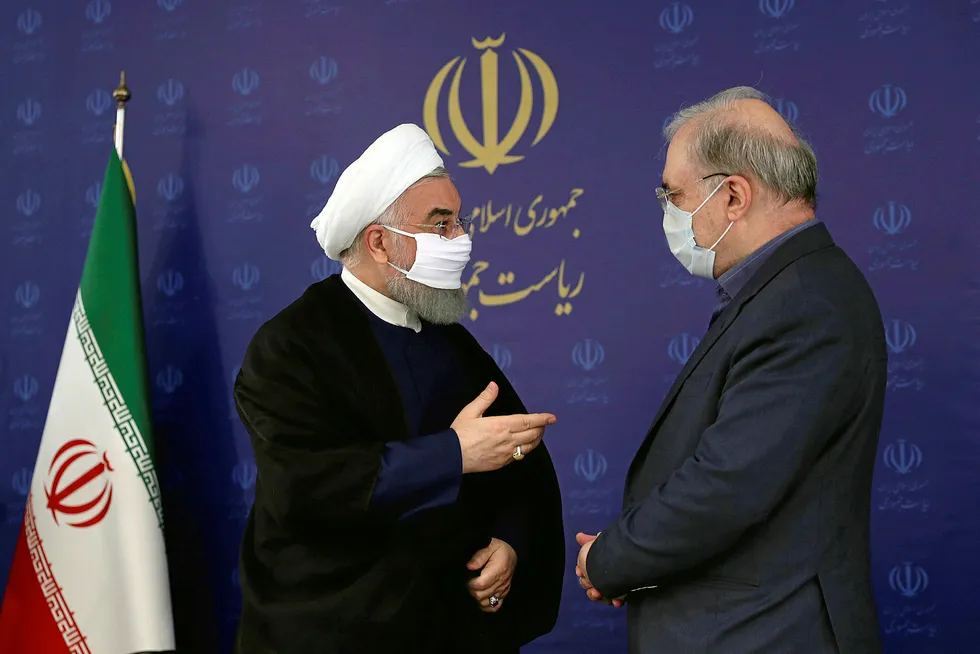 Decisions: Iranian President Hassan Rouhani (left) talks with Health & Medical Education Minister Saeed Namaki during a meeting about the Covid-19 threat in the country