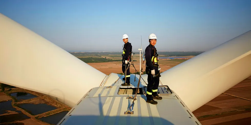 Chinese workers on Vestas turbine.