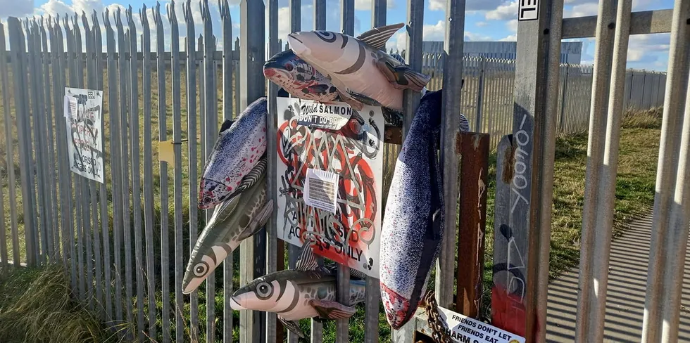 Signs hang on the gate of the site planned for a 5,000 metric-ton land-based salmon project in Grimsby.