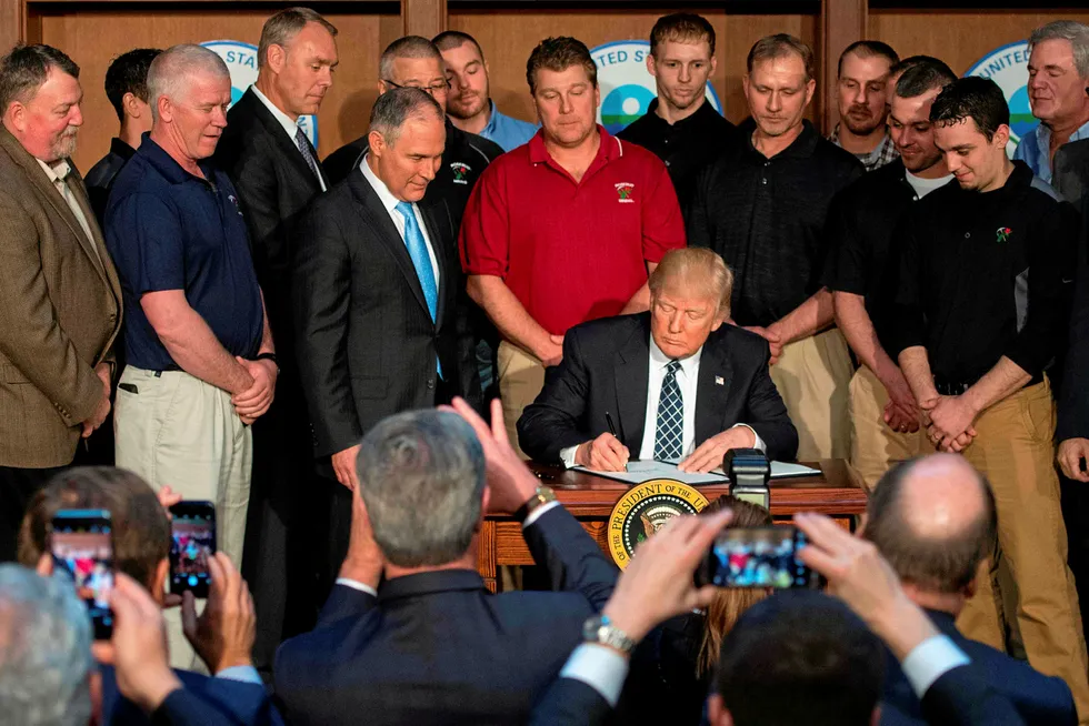 Dedicated follower of fossil: Surrounded by miners from Rosebud Mining, US President Donald Trump signs the Energy Independence Executive Order at the Environmental Protection Agency (EPA) Headquarters in Washington,