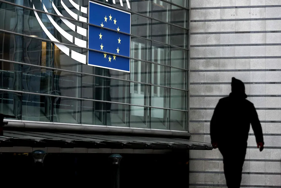 Restrictions: A man walks near the entrance of the European Parliament in Brussels.