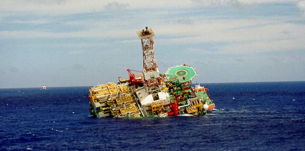 A damaged Petrobras oil rig slipping into the ocean back in 2001.