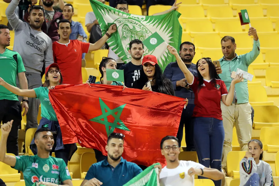 Cheered on: fans of Raja Casablanca football club cheer for their team and wave a Moroccan national flag at a 2019 match