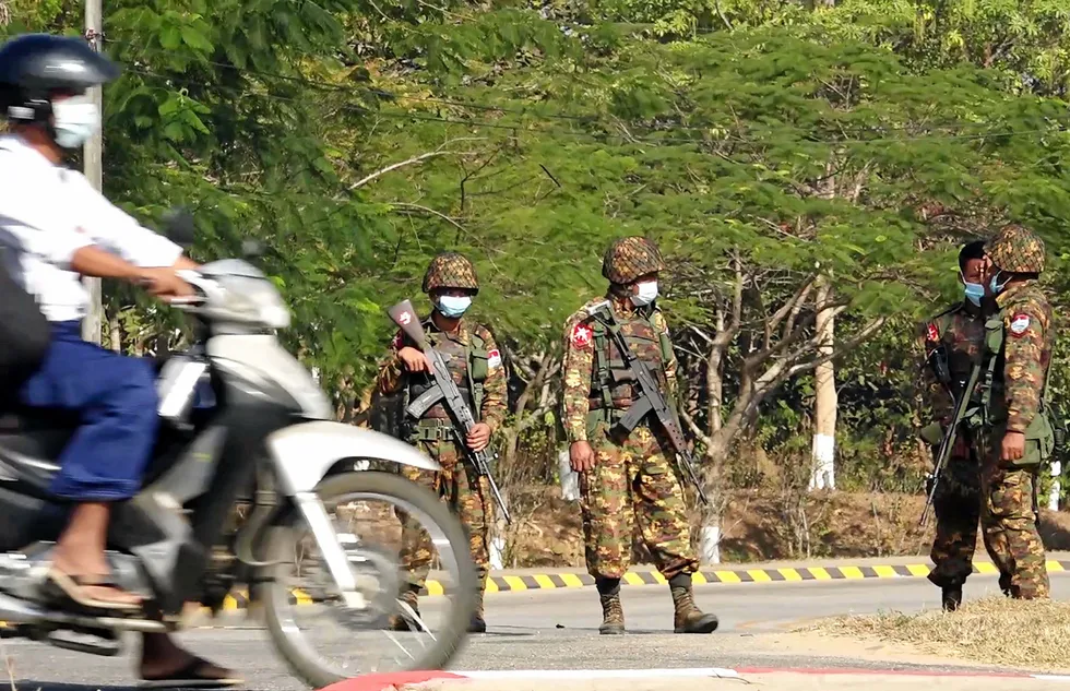 Soldiers: standing guard on a street in Naypyidaw on 1 February 2021 after the military detained Aung San Suu Kyi and the country's president in a coup